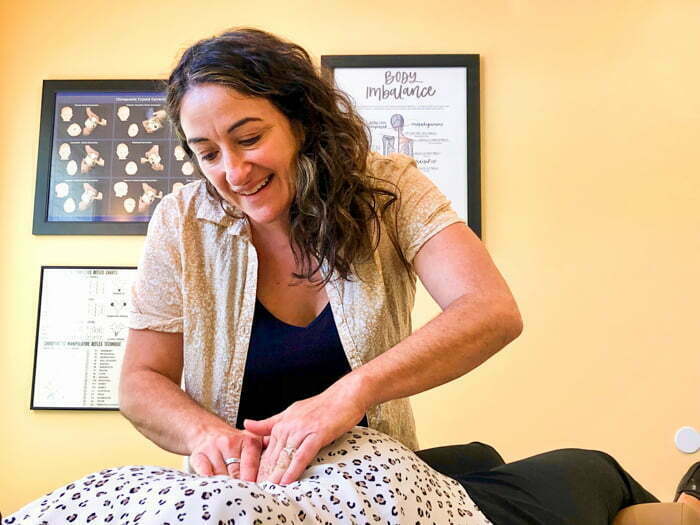 Doctor giving chiropractic care to pregnant woman